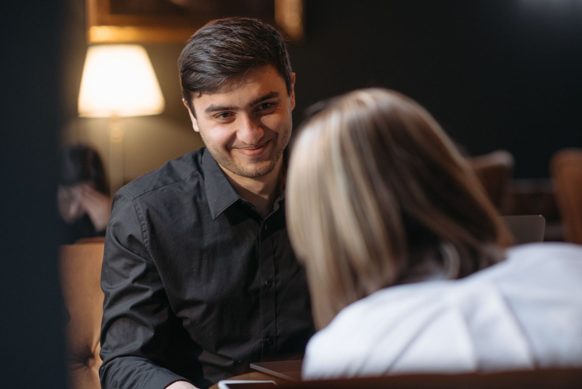 Two people talking over coffee