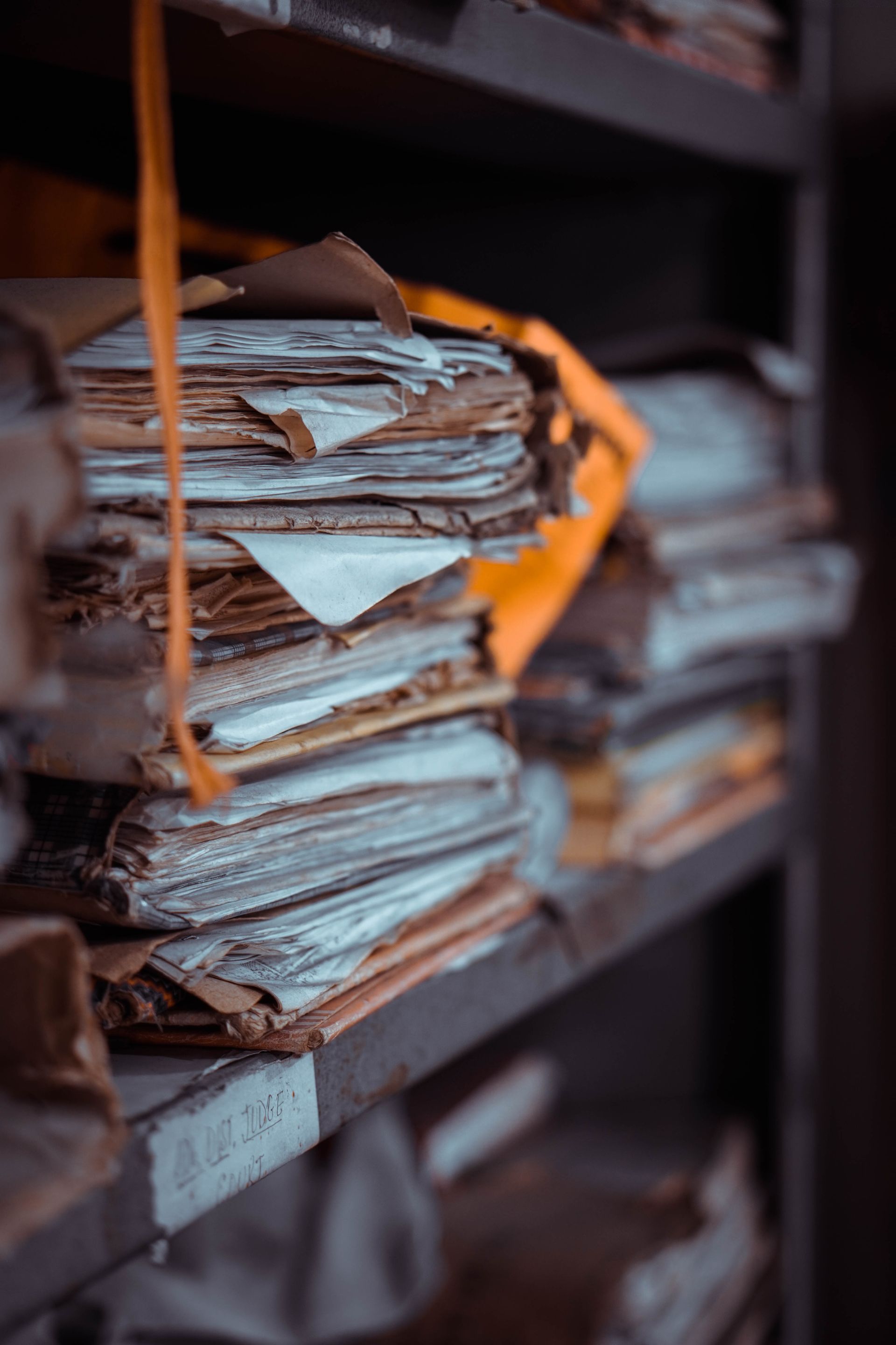 Dusty stacks of old papers on a shelf